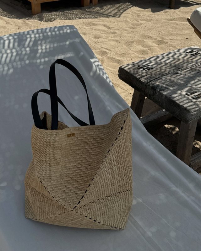 hannahlewisstylist wearing LOEWE + Paula's Ibiza Puzzle Fold large leather-trimmed raffia tote