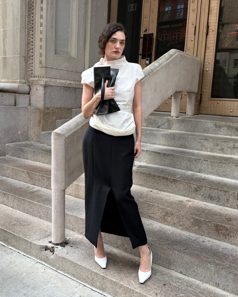 MAGDA BUTRYM Fitted draped blouse with stand collar in cream, CAMILLA AND MARC Caius High Corset Waist Midi Skirt, JUDE Fame leather pumps and GIA STUDIOS Envelope Handle-Clutch in Leather worn by Emily Bonita | Emily Bonita Outfits and Style