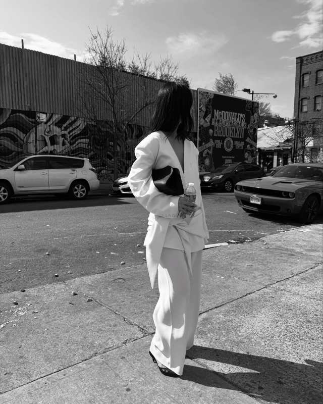 The Row Peggy Clutch Shoulder Bag in Saddle Leather worn by Mimi Nguyen | Mimi Nguyen Outfits and Style