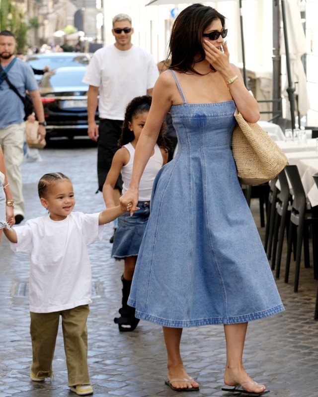 Marni Sleeveless Paneled Denim Midi Dress, THE ROW Beach Flip Flop - Clear and THE ROW Oregon Bag worn by Kylie Jenner in Rome, Italy.
