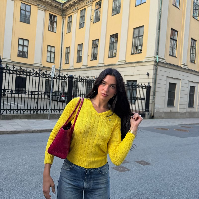 Polo Ralph Lauren Cable-Knit Cotton V-Neck Sweater and BVLGARI Octo Finissimo 37 mm Watch worn by Dua Lipa | Dua Lipa Outfits and Style