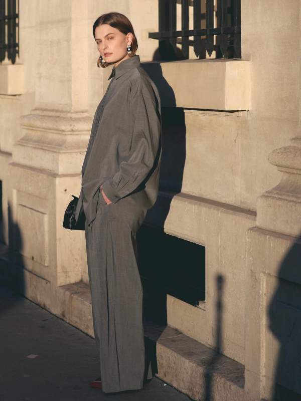 Jacquemus long-sleeve shirt and Jacquemus pleated trousers worn by Christie Tyler | Christie Tyler Outfits and Style