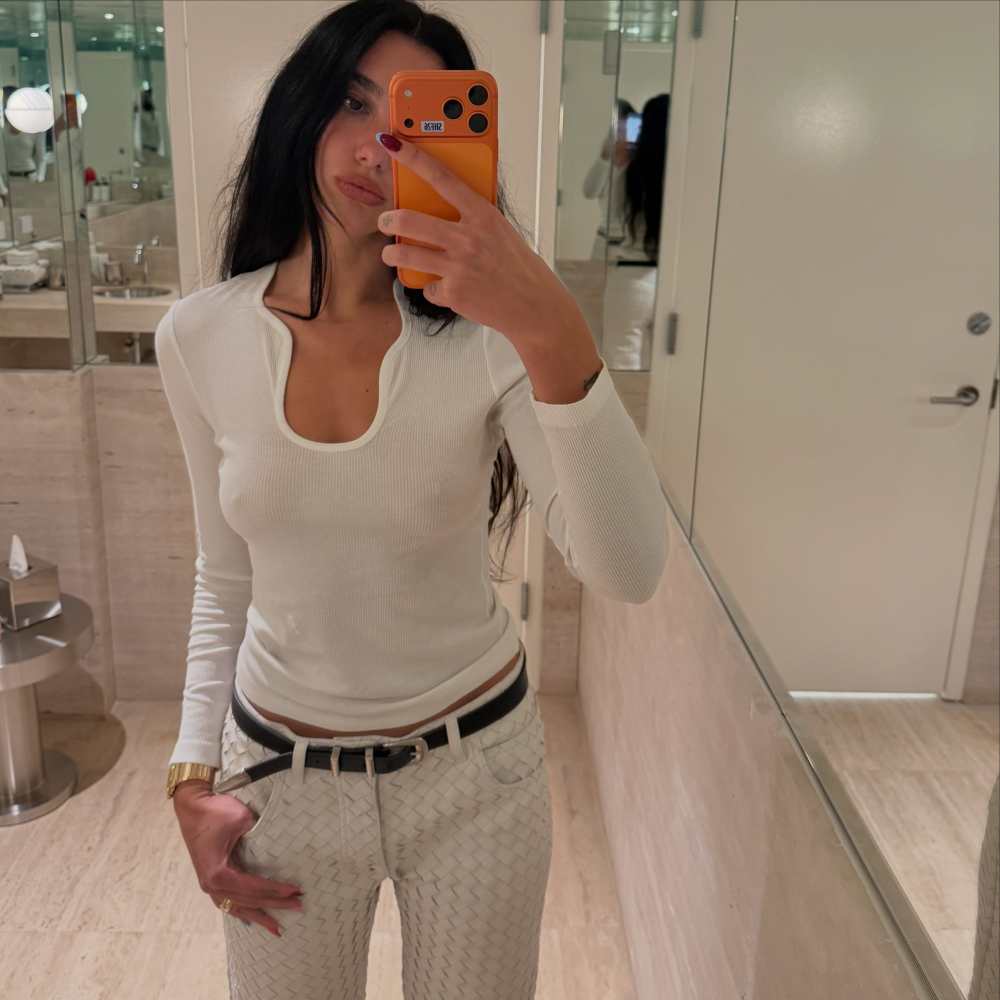 FERRAGAMO ribbed top with plunging neckline worn by Dua Lipa | Dua Lipa Outfits and Style