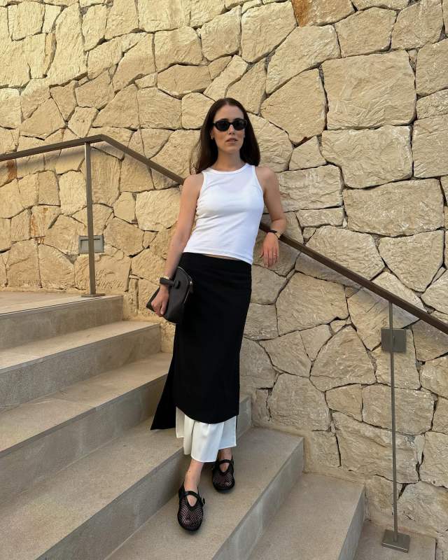 THE ROW Ellie leather clutch, The Garment Black Treviso Midi Skirt and ALAIA Mesh Mary Jane Ballerina Flats worn by Annabel Rosendahl | annabelrosendahl's closet