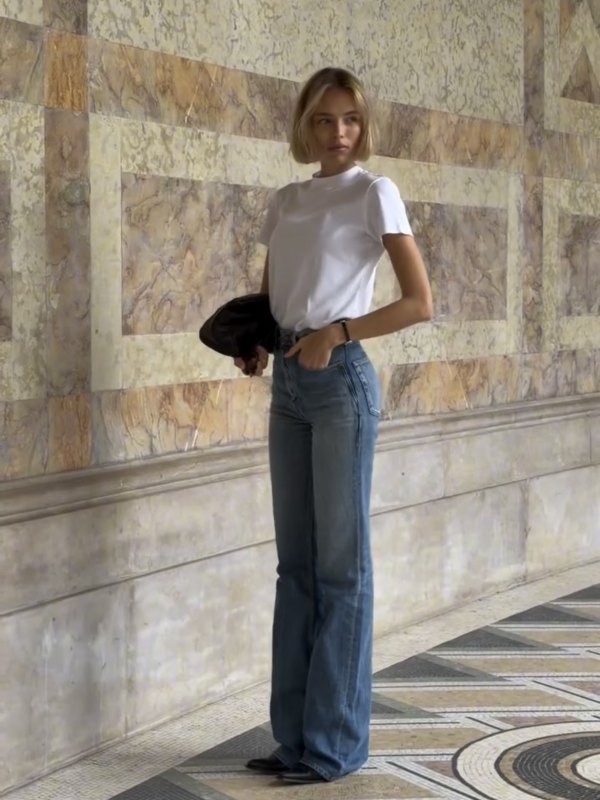 Vince short-sleeve mock-neck T-shirt, Saint Laurent v-waist long baggy jeans, Tom Ford Guillaume Sunglasses, ARMARIUM Eloisa clutch in nappa leather and Cartier Baignoire watch worn by Marie-Lou | Marie-Lou Outfits and Style