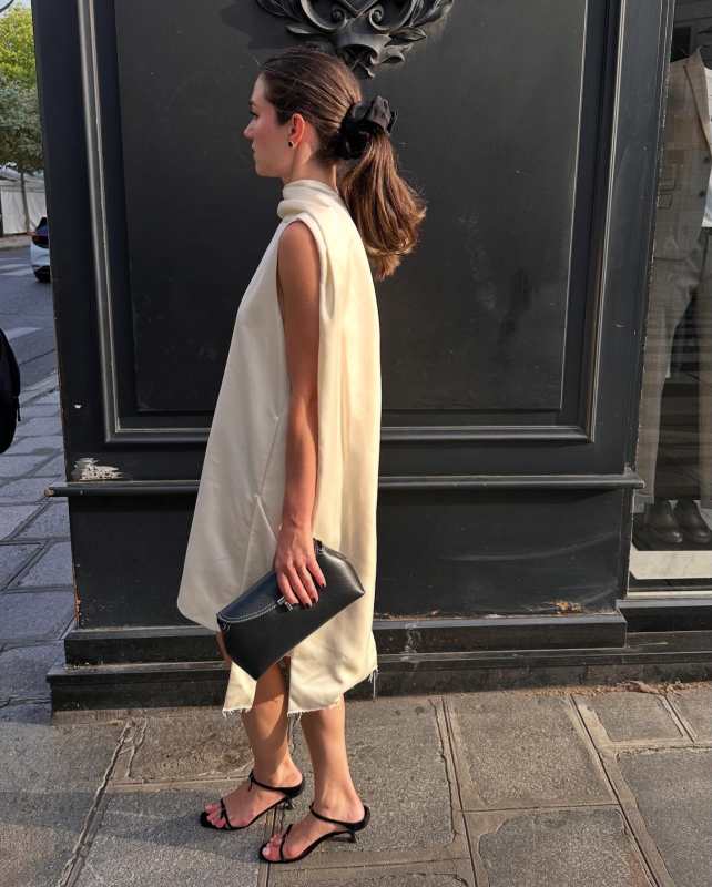 Toteme Cocoon deconstructed satin minidress, GIA STUDIOS Velvet Black Buckle Slides Sandals and Toteme T-Lock Top Handle Bag in Pebble Grain Leather worn by Ilirida Krasniqi | Ilirida Krasniqi Outfits and Style