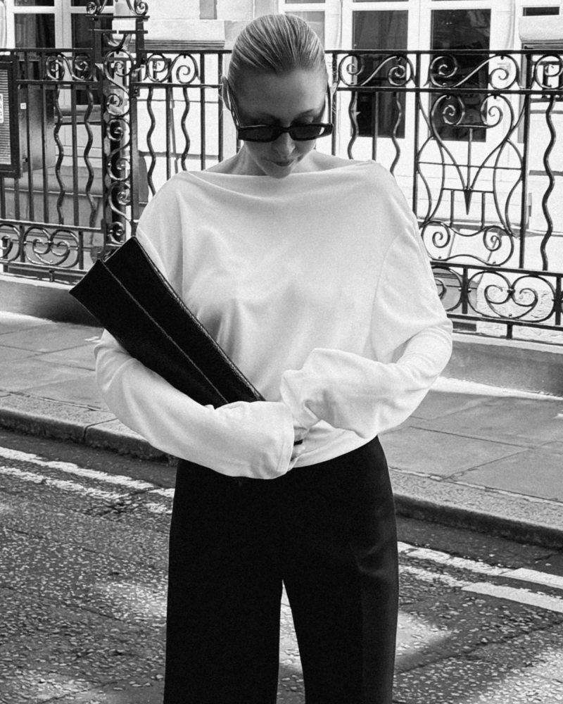 ALAIA Square-frame sunglasses, Jacquemus Croisière draped open-back crêpe jersey top, Soeur Black crocodile-embossed leather clutch bag and Khaite Walter Crop Flare Pants worn by Victoria | Victoria Outfits and Style