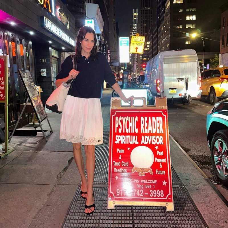 SANDY LIANG THONG MULE 90 IN BLACK SPAZZOLATO, Miu Miu Poplin Skirt and HommeGirls Navy Wool Polo worn by Alexa Chung | Alexa Chung Outfits and Style