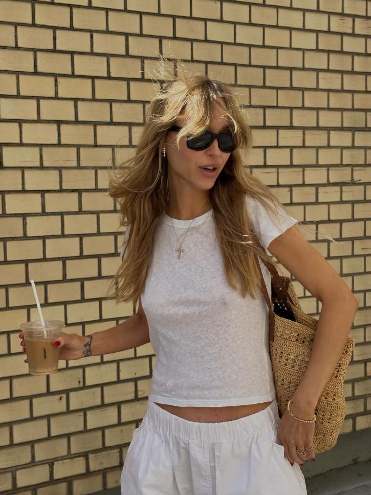 SLVRLAKE Easy cotton T-shirt, Saint Laurent Panier medium leather-trimmed raffia tote, WARDROBE.NYC Beach Pant, Sophie Bille Brahe Tennis Nuage Bracelet and The Row Dune grosgrain thong sandals worn by Pernille Teisbaek | Pernille Teisbaek Outfits and Style