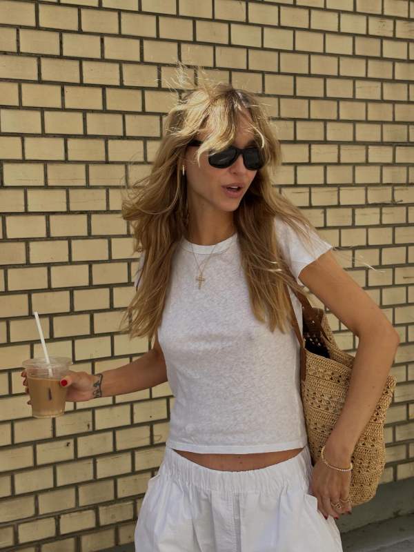 SLVRLAKE Easy cotton T-shirt, Saint Laurent Panier medium leather-trimmed raffia tote, WARDROBE.NYC Beach Pant, Sophie Bille Brahe Tennis Nuage Bracelet and The Row Dune grosgrain thong sandals worn by Pernille Teisbaek | Pernille Teisbaek Outfits and Style