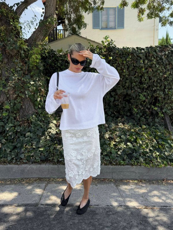 DISSH Sloane White Long Sleeve Crew Knit Top, The Garment Fleur Slip Skirt, H&M Round Sunglasses, THE ROW Fay Flat Two worn by Elsa Hosk.