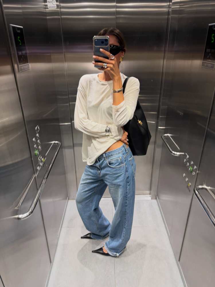 WEEKDAY LONG-SLEEVED BOXY COTTON T-SHIRT, DeMellier The Siena Bucket, The Frankie Shop Dalston Jeans - Medium Wash and Saint Laurent SL 914 worn by Virginie Martin